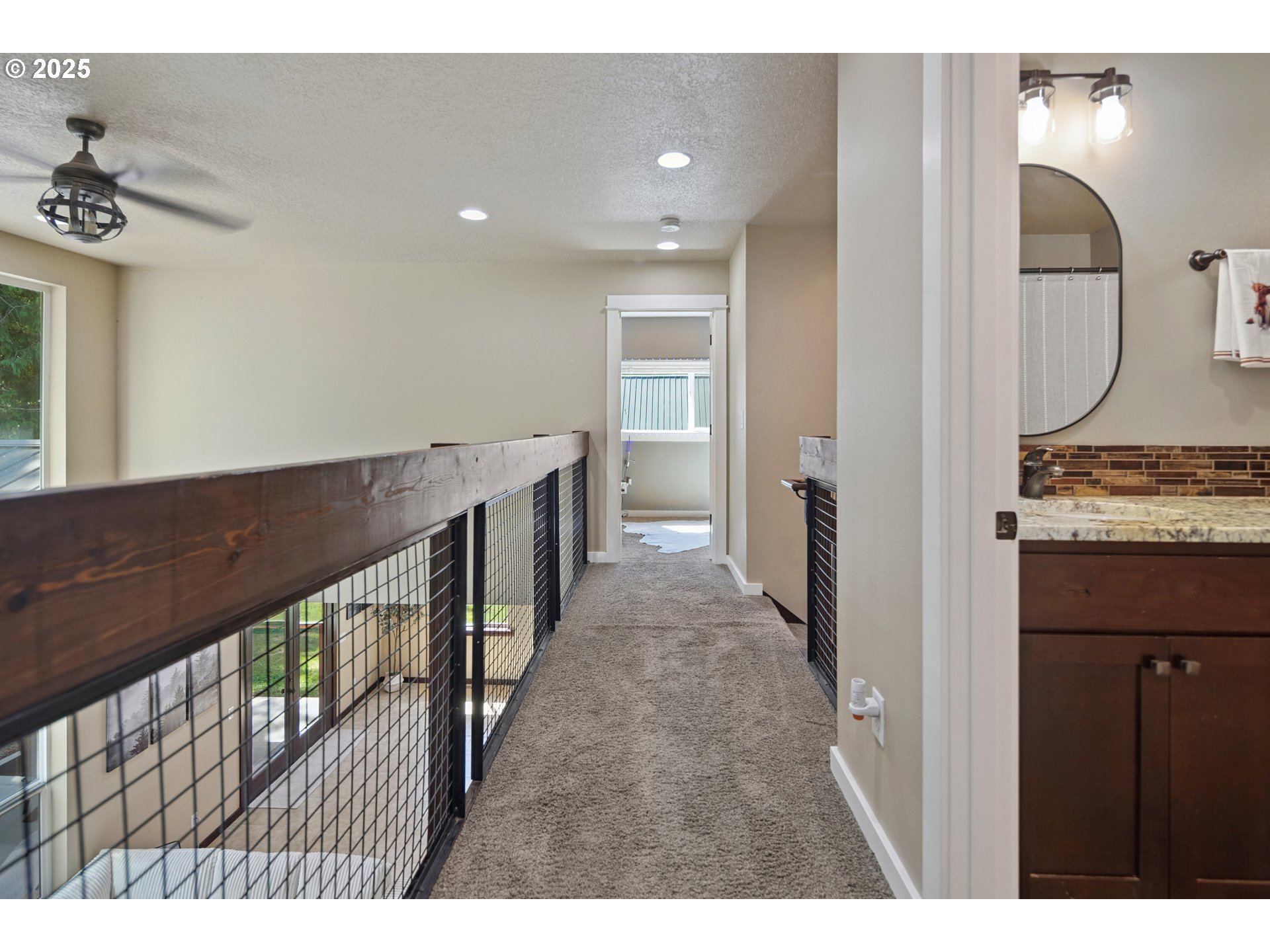 57214 East Marmot Road Sandy, OR 97055 - Photo 24 of 48 a view of a hallway with wooden floor and staircase