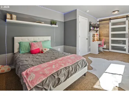 a bedroom with a bed and a mirror