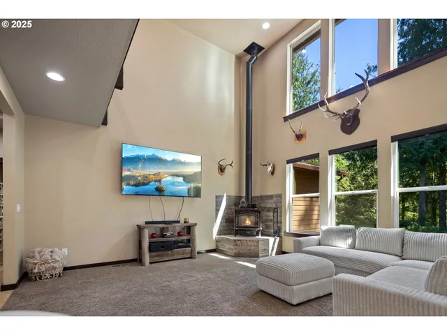 a living room with furniture a large window and flat screen tv