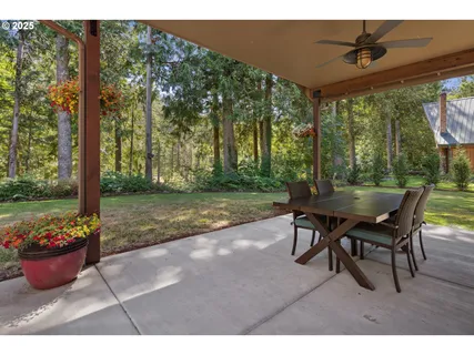 a view of a patio with a table chairs and a yard