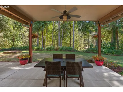 a backyard of a house with a table and chairs