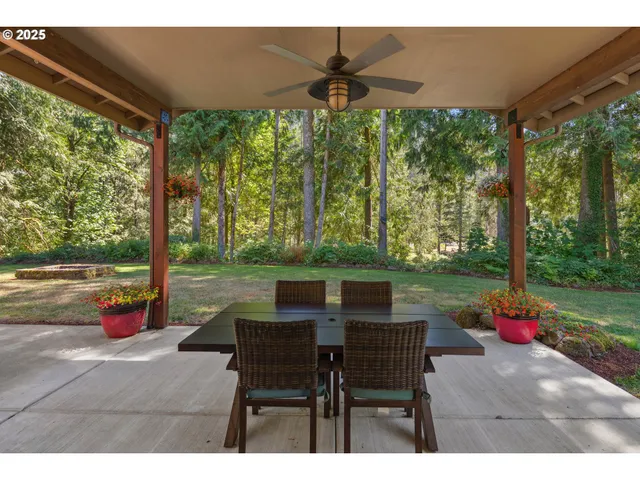 a backyard of a house with a table and chairs