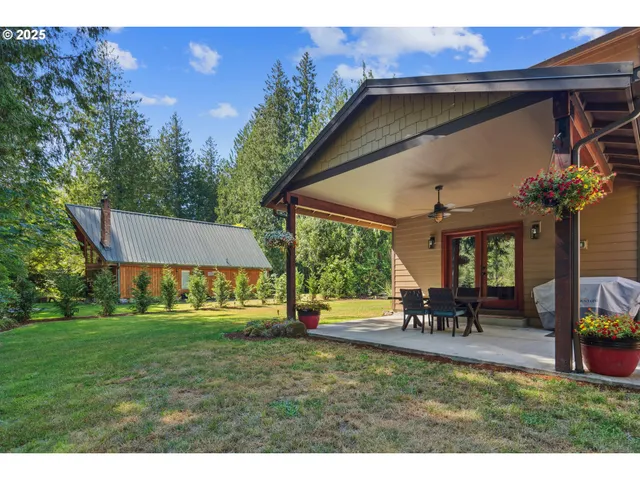 a view of a house with backyard porch and sitting area
