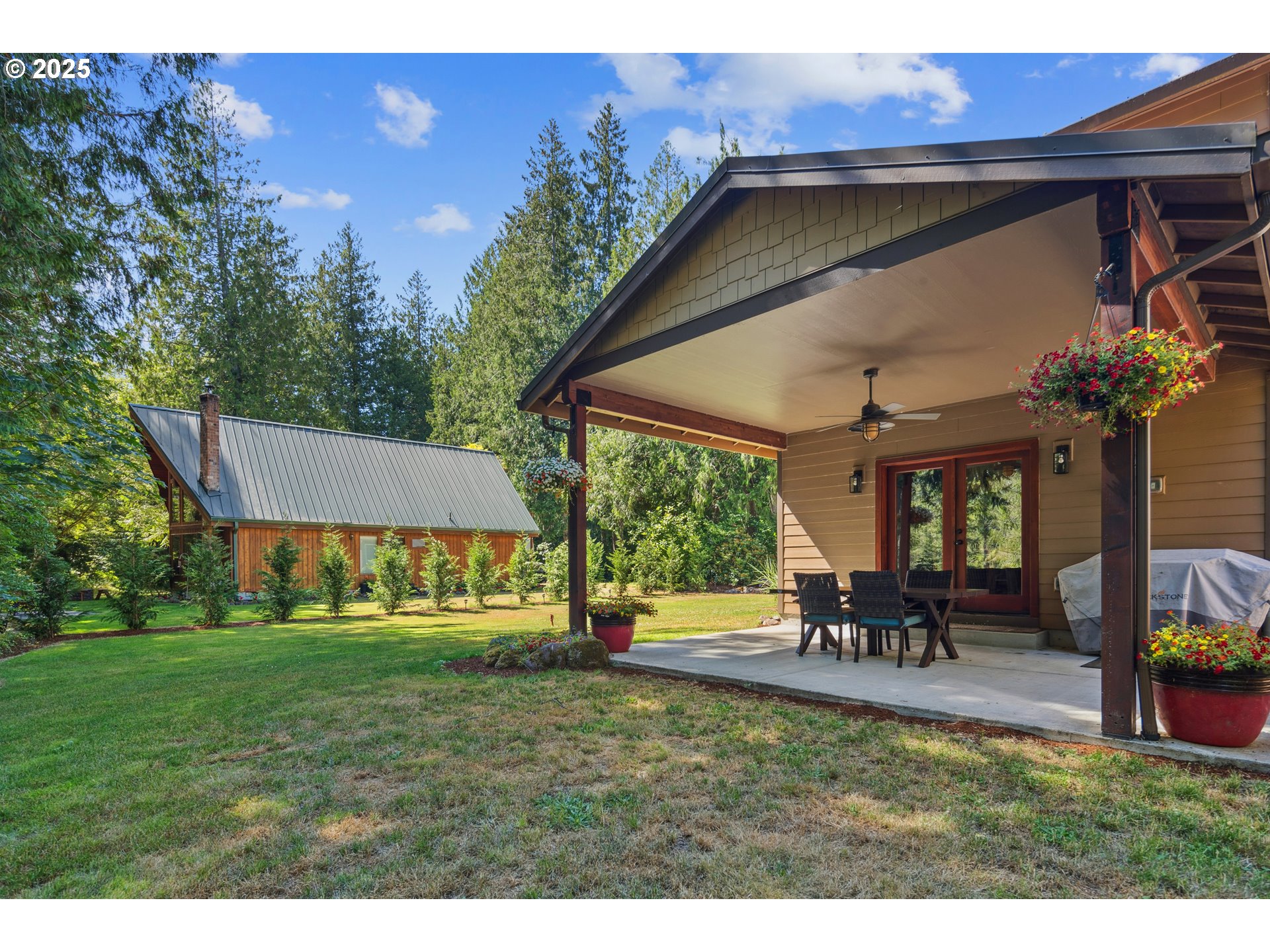 57214 East Marmot Road Sandy, OR 97055 - Photo 39 of 48 a view of a house with backyard porch and sitting area