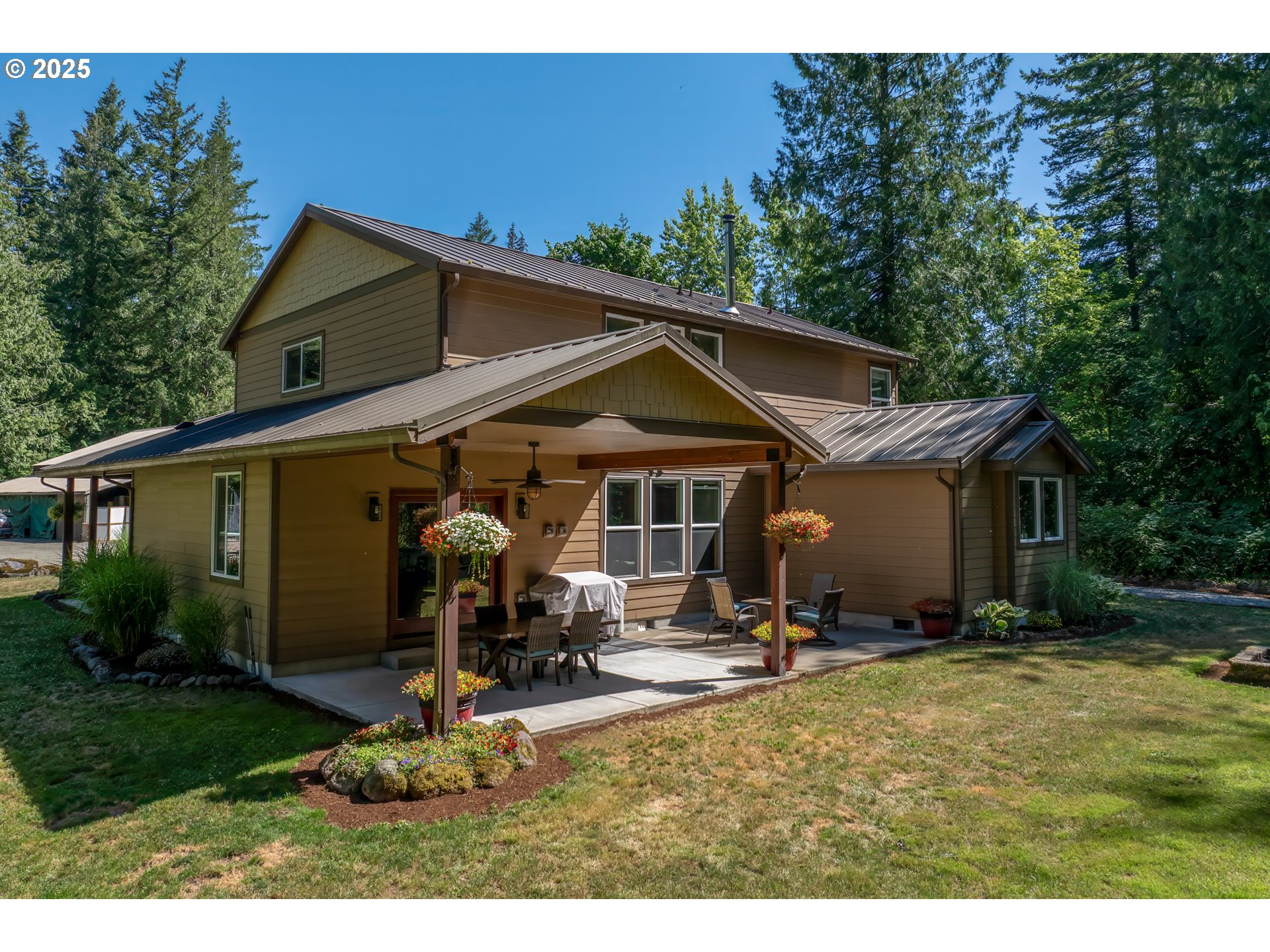 57214 East Marmot Road Sandy, OR 97055 - Photo 40 of 48 a view of a house with backyard and trees