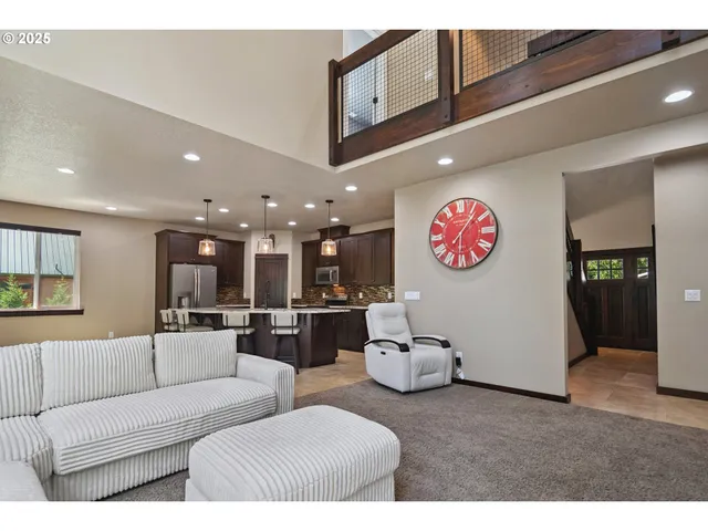a living room with furniture and kitchen view