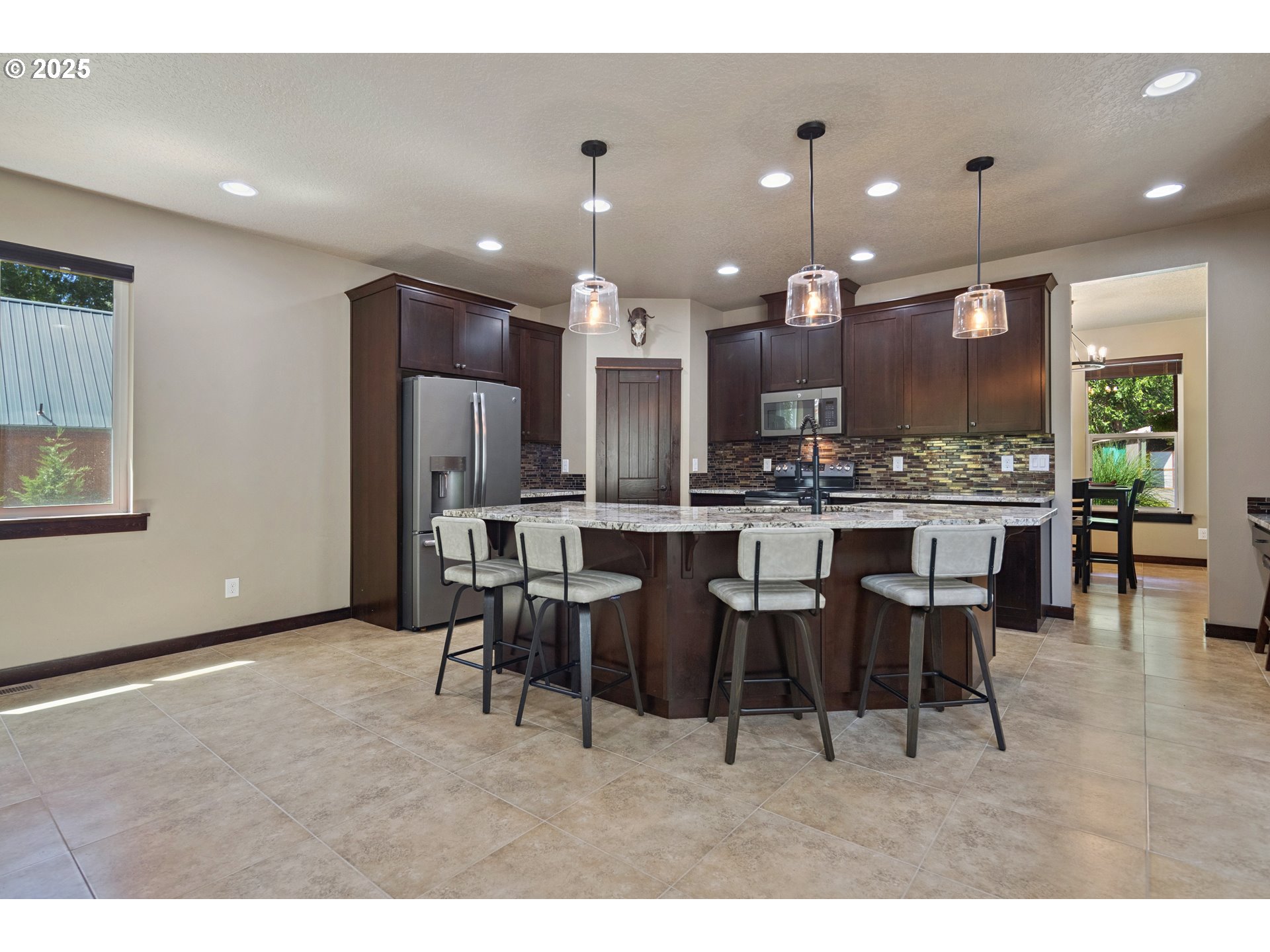 57214 East Marmot Road Sandy, OR 97055 - Photo 5 of 48 a large kitchen with a table and chairs