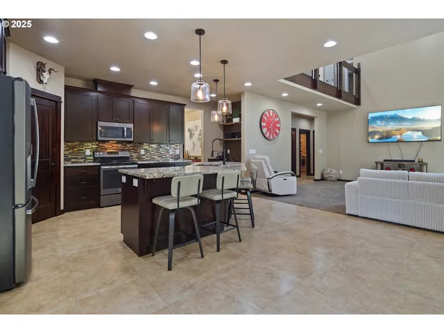 a large kitchen with a table and chairs