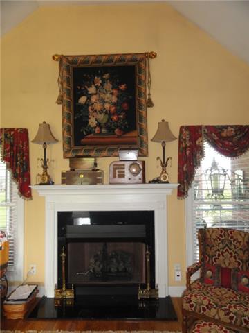 220 Rock Bridge Road Gallatin, TN 37066 - Photo 3 of 12 a fireplace with a clock on top of it