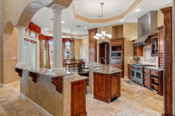 a kitchen island with stainless steel appliances kitchen island granite countertop a sink and cabinets