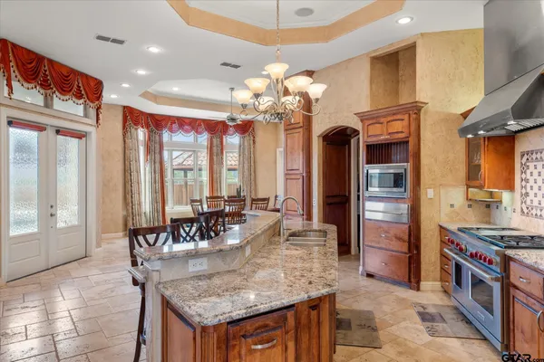 a stove top oven sitting inside of a kitchen