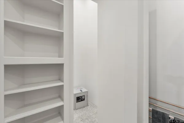 a living room with furniture gym equipment and a window