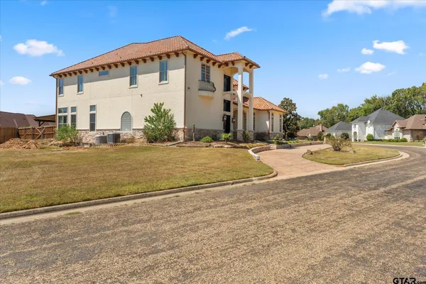 a view of a white house with a yard