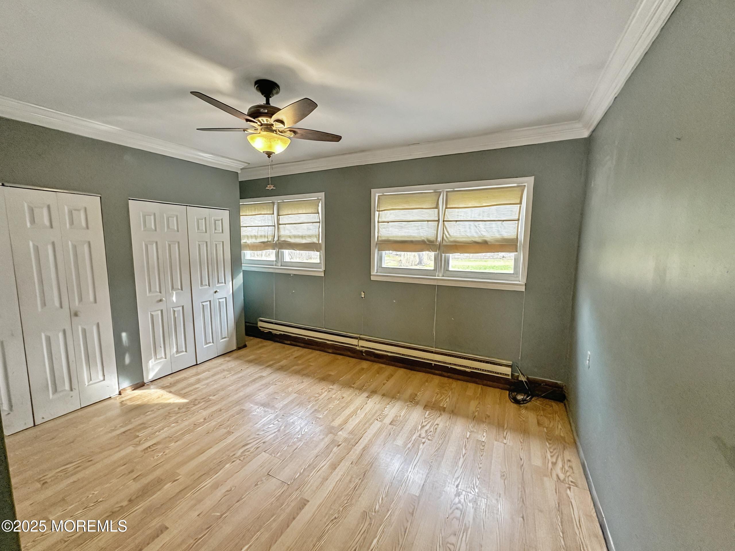 5 Pittenger Pond Road Freehold, NJ 07728 - Photo 11 of 20 wooden floor in an empty room with a window