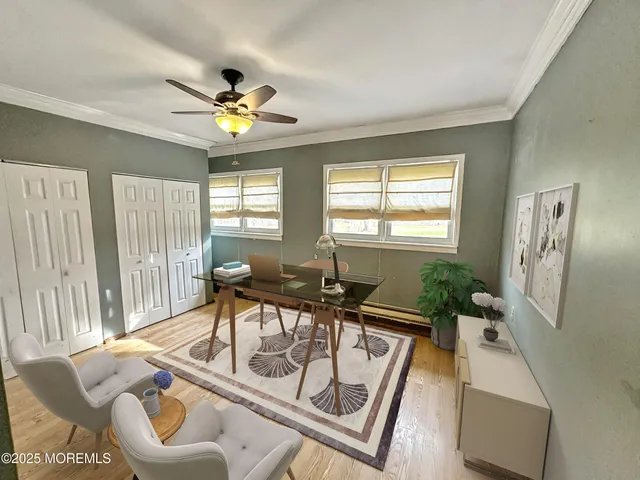 an empty room with windows and fan