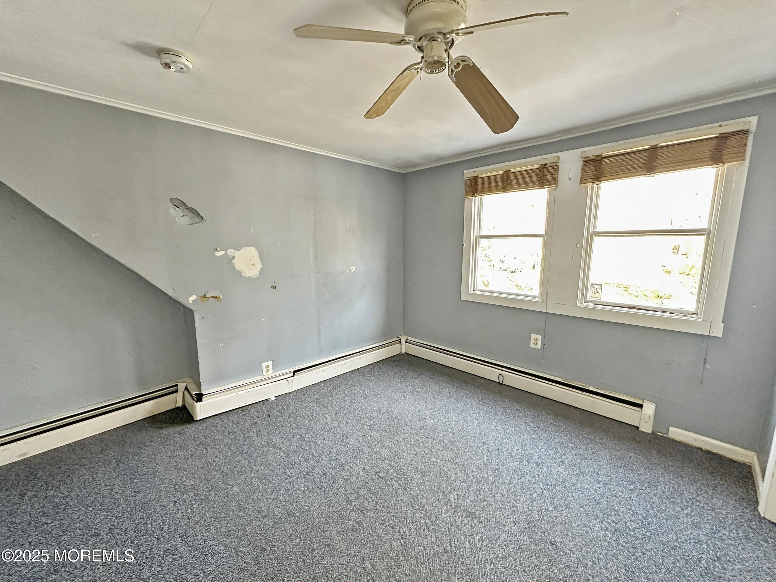 5 Pittenger Pond Road Freehold, NJ 07728 - Photo 13 of 20 an empty room with windows and fan