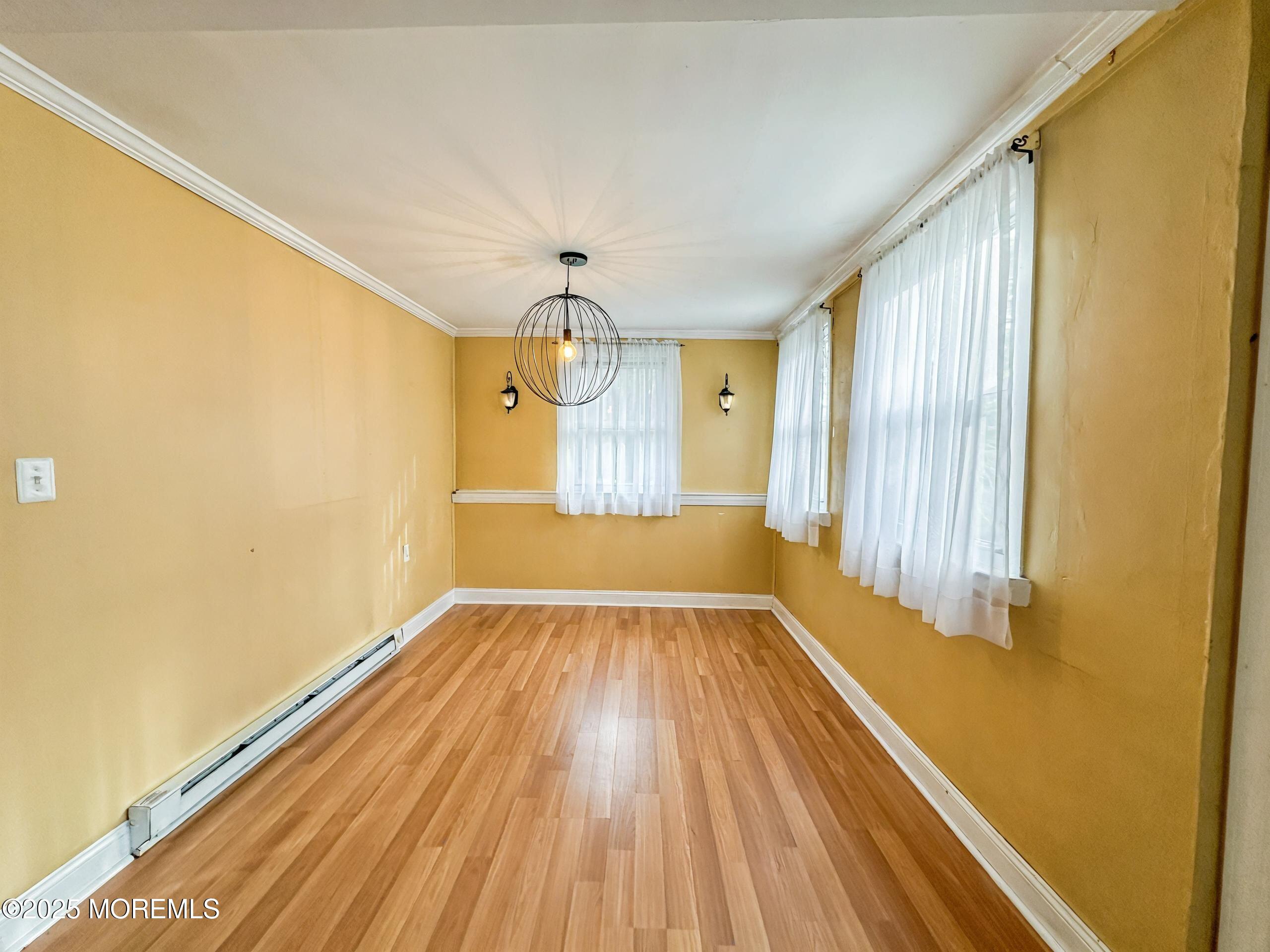 5 Pittenger Pond Road Freehold, NJ 07728 - Photo 17 of 20 a view of empty room with wooden floor and fan