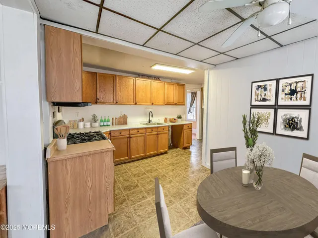 a kitchen with kitchen island granite countertop a sink cabinets and stainless steel appliances