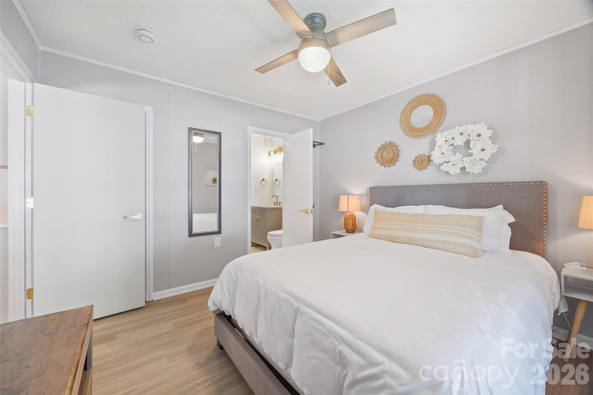 5280 Masons Ferry Road Clover, SC 29710 - Photo 15 of 45 a bedroom with a large bed and a chandelier