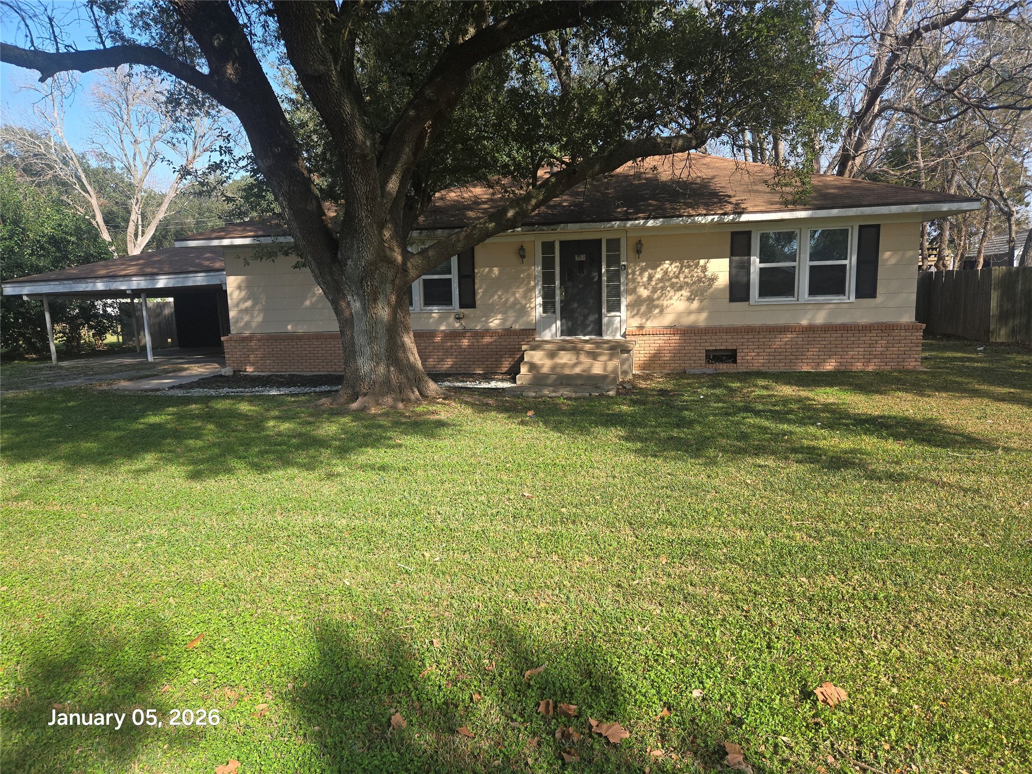 a front view of a house with a yard garage and outdoor seating