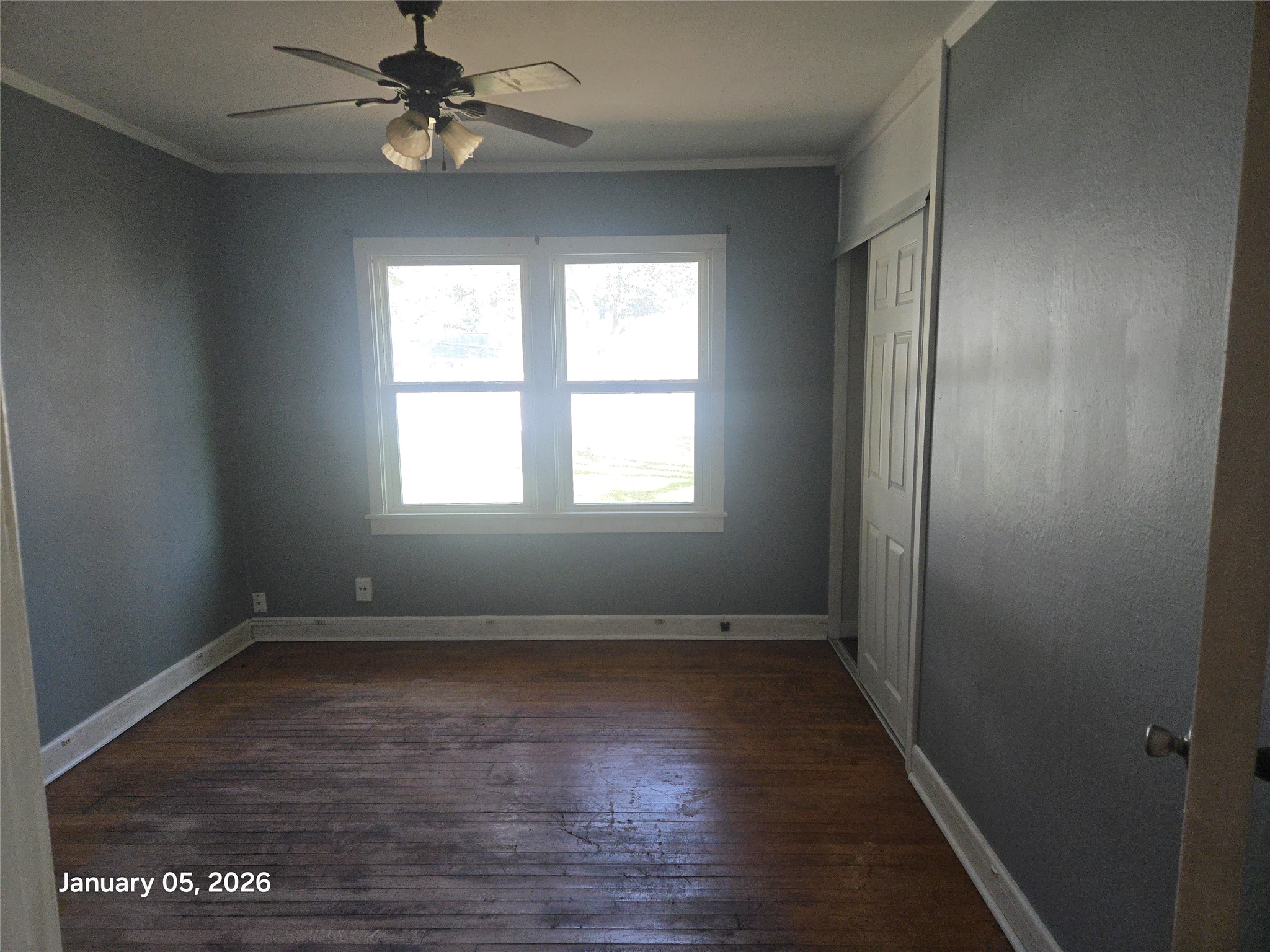 515 Breezy Lane Wharton, TX 77488 - Photo 12 of 18 a view of an empty room with wooden floor and a window