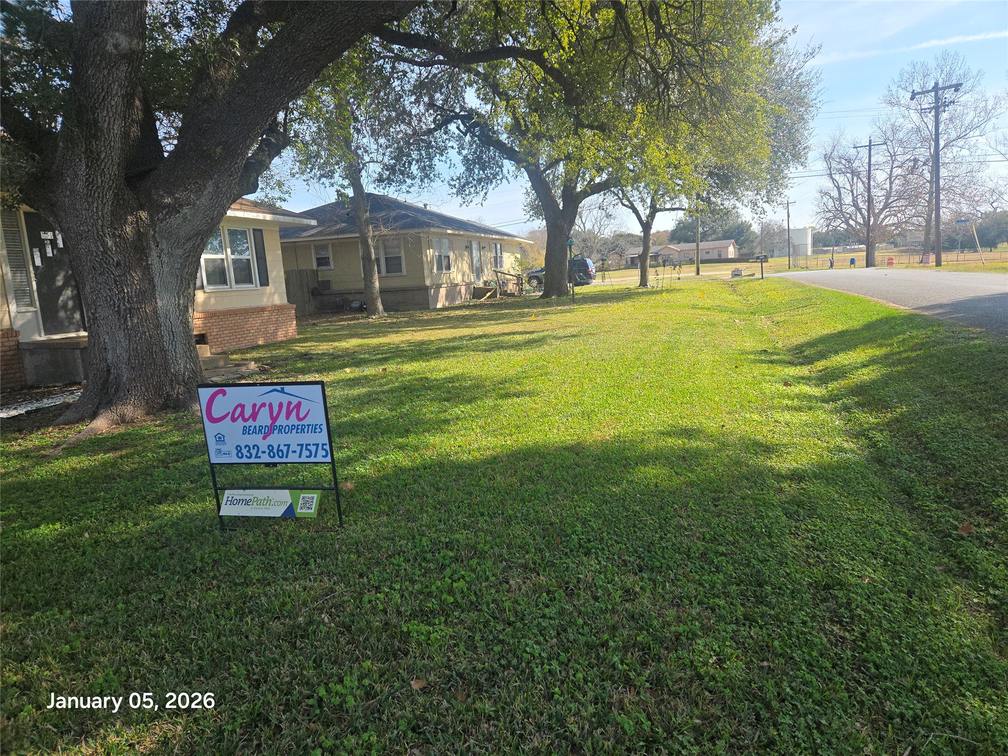 515 Breezy Lane Wharton, TX 77488 - Photo 17 of 18 a sign board with lawn chairs and a yard