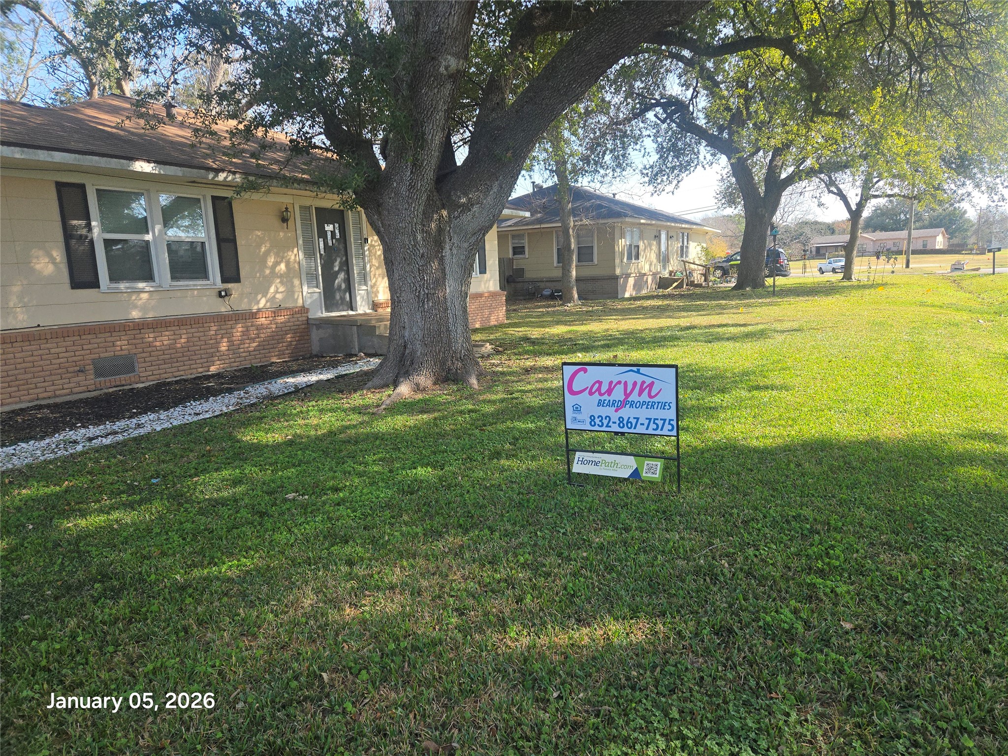 515 Breezy Lane Wharton, TX 77488 - Photo 18 of 18 a sign that is sitting in front of a house with a big yard