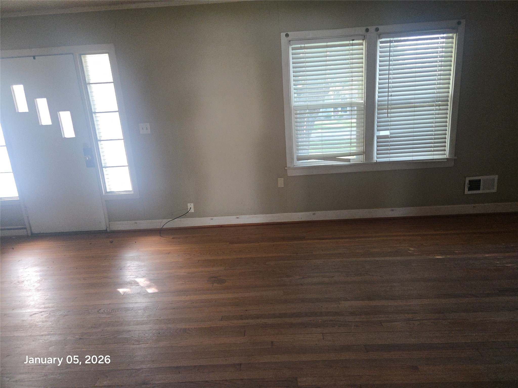 515 Breezy Lane Wharton, TX 77488 - Photo 9 of 18 an empty room with wooden floor and windows