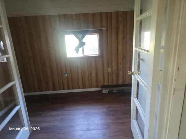 an entryway with wooden floor and a window