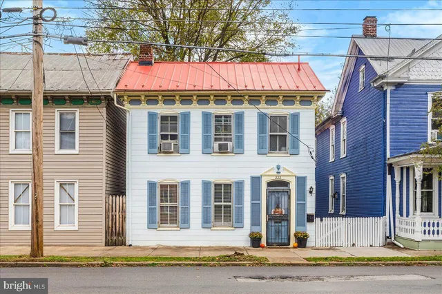 a front view of a residential apartment building with a yard