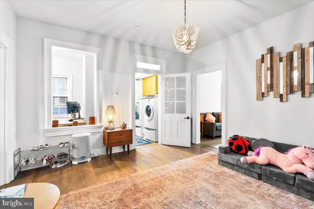 a living room with furniture and a chandelier