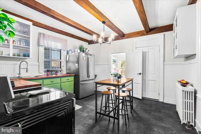 a dining room with furniture and a kitchen view