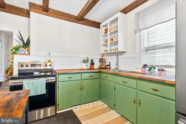 a kitchen with cabinets a window and sink