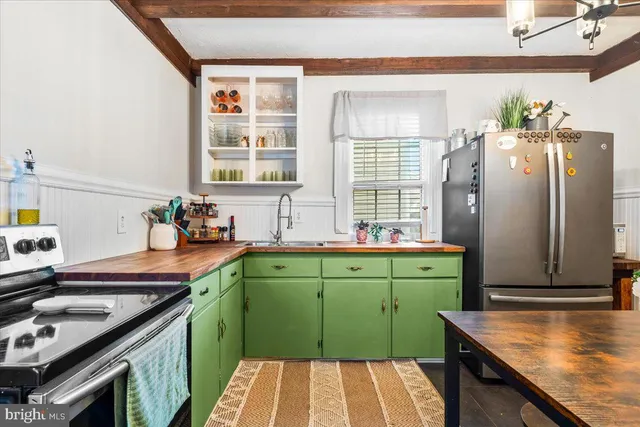 a kitchen with sink refrigerator and window