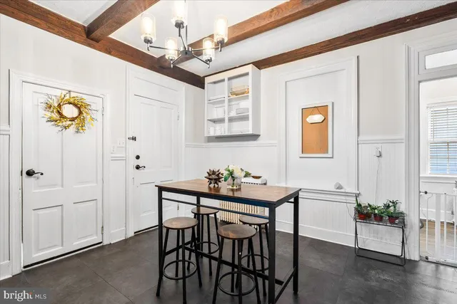 a dining room with furniture and window