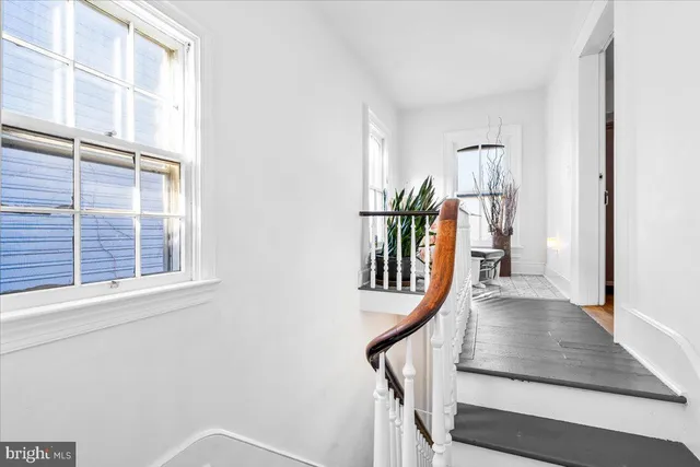 a view of entryway with wooden floor and stairs