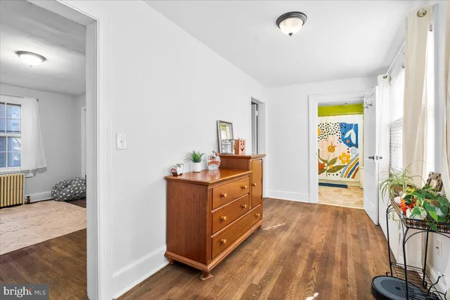 a spacious bathroom with a double vanity sink a mirror and a bathtub
