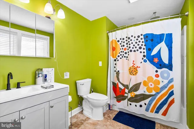 a bathroom with a sink and mirror with toilet