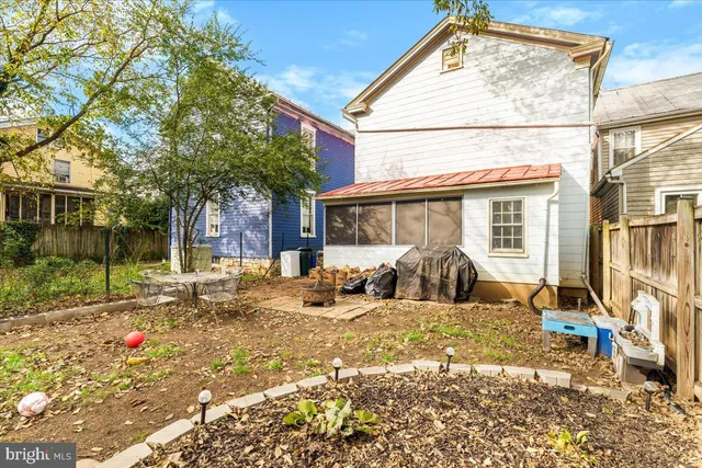a view of a house with backyard and sitting area