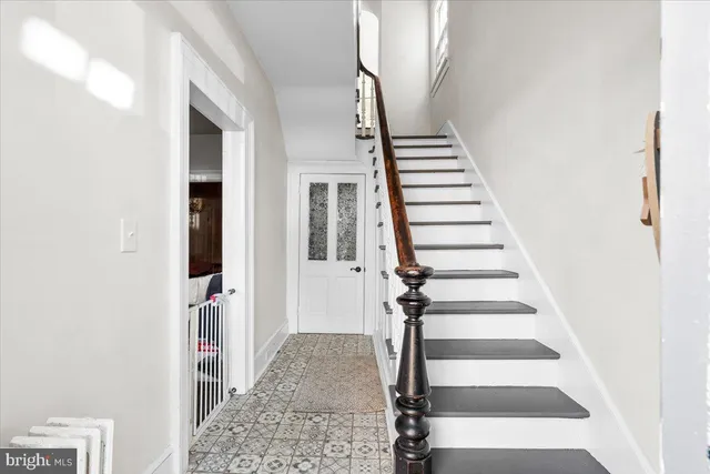 a view of entryway and hall with wooden floor