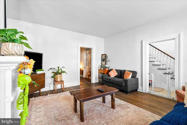 a living room with furniture and a lamp