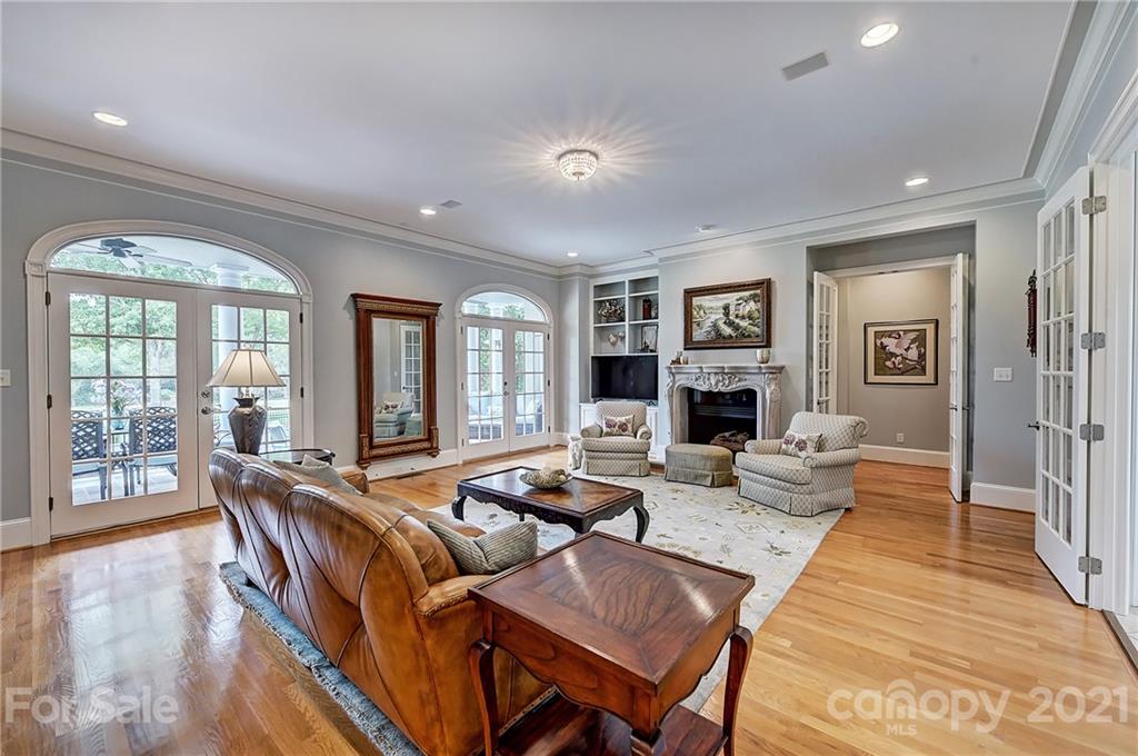 13710 Robert Walker Drive Davidson, NC 28036 - Photo 17 of 48 a living room with fireplace furniture and a wooden floor