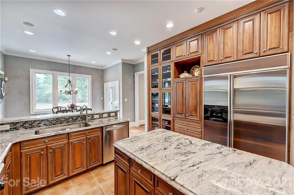 13710 Robert Walker Drive Davidson, NC 28036 - Photo 23 of 48 a kitchen with stainless steel appliances granite countertop a sink stove and refrigerator