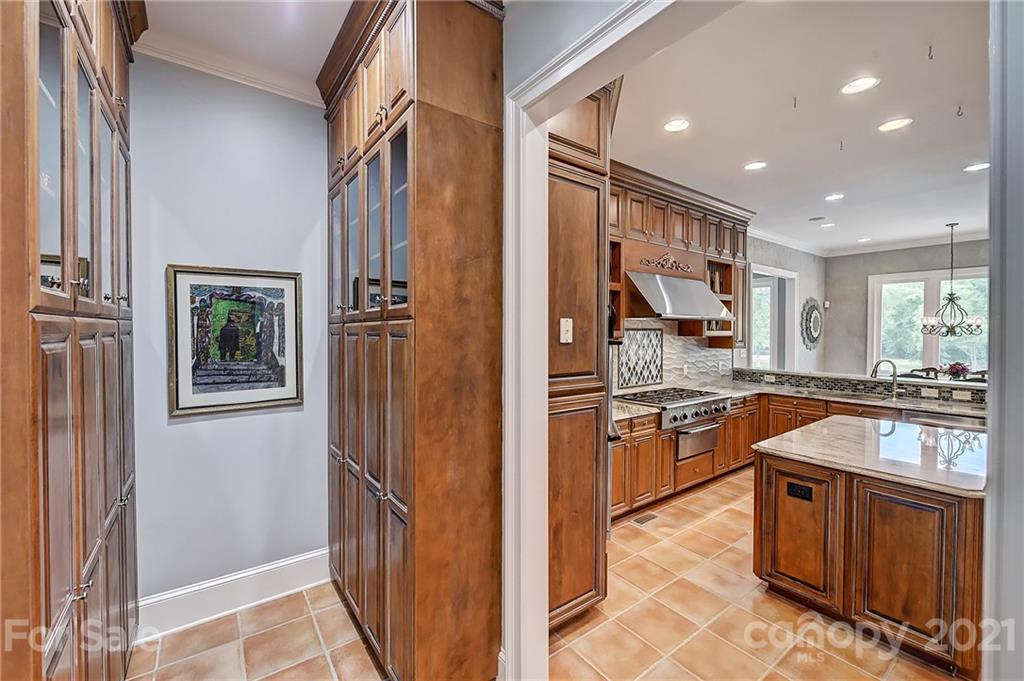 13710 Robert Walker Drive Davidson, NC 28036 - Photo 24 of 48 a kitchen with stainless steel appliances granite countertop a stove and a refrigerator