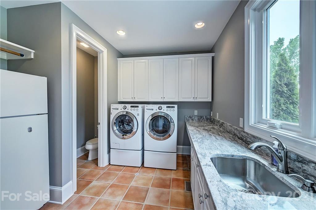 13710 Robert Walker Drive Davidson, NC 28036 - Photo 30 of 48 a utility room with sink dryer and washer