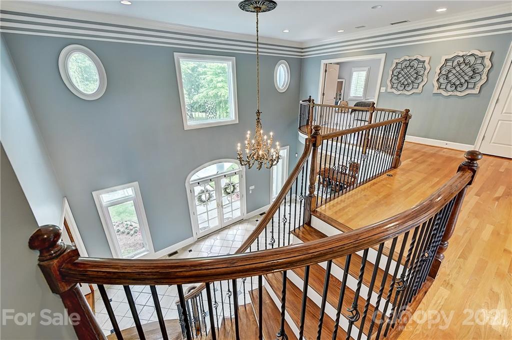 13710 Robert Walker Drive Davidson, NC 28036 - Photo 31 of 48 a view of a hallway with wooden floor and windows
