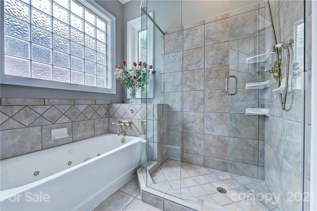 13710 Robert Walker Drive Davidson, NC 28036 - Photo 34 of 48 a bathroom with a bathtub and shower