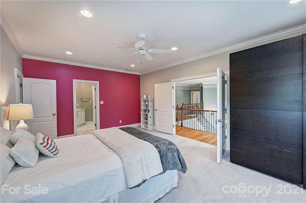 13710 Robert Walker Drive Davidson, NC 28036 - Photo 35 of 48 a bedroom with a bed and a chandelier