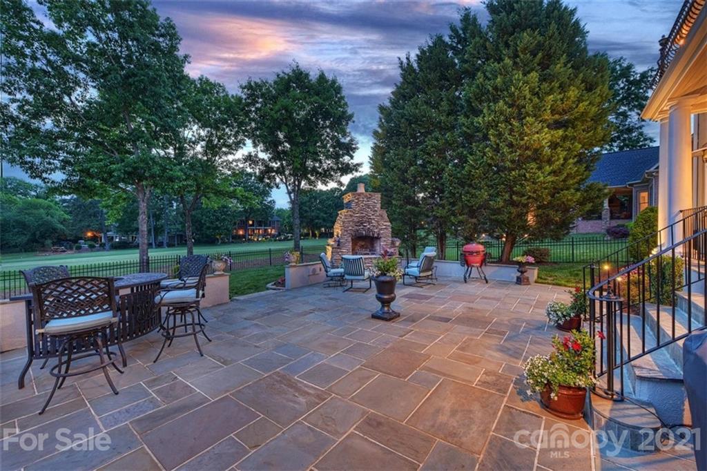 13710 Robert Walker Drive Davidson, NC 28036 - Photo 5 of 48 a view of a patio with a table and chairs and a fire pit