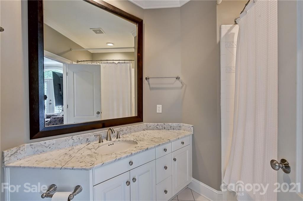 13710 Robert Walker Drive Davidson, NC 28036 - Photo 41 of 48 a bathroom with a granite countertop sink and a mirror